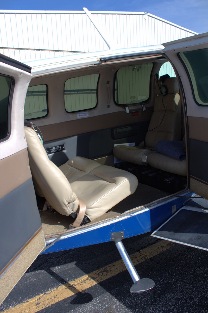 Open double doors and club seating aboard Beechcraft Baron 58 N169RR